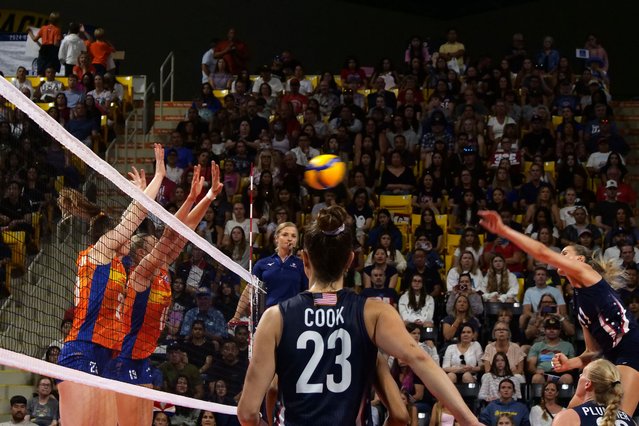 Kelsey Robinson Cook #23 of the United States looks on as teammate Annie Drews #11 spikes the ball during a match between the United States and Netherlands as part of the 2024 USA Volleyball Cup presented by hoag at Walter Pyramid on July 14, 2024 in Long Beach, California. (Photo by Kaelin Mendez/Getty Images/AFP Photo)