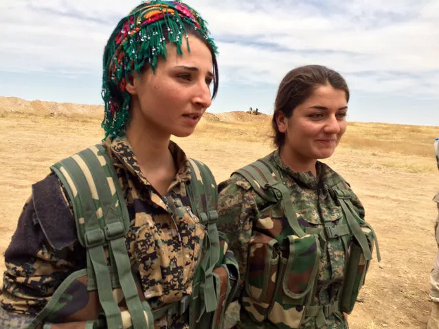 In this photo taken May 21, 2016, Barcham Zana, left, and Helene Osman, at a training camp in northern Syria where US military advisers are working with local Arab volunteers who want to fight the Islamic State. At age 20, Zana knows her enemy. It is the Islamic State, which she calls “darkness”. Two cousins were killed by IS, she said, so for her this is not an abstract threat. (Photo by Robert Burns/AP Photo)
