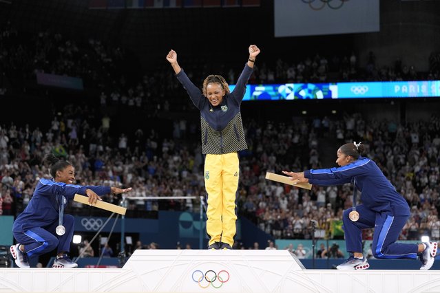 Silver medalist Simone Biles, of the United States, left, and bronze medalist Jordan Chiles, of the United States, right, bow to gold medalist Rebeca Andrade, of Brazil, during the medal ceremony for the women's artistic gymnastics individual floor finals at Bercy Arena at the 2024 Summer Olympics, Monday, August 5, 2024, in Paris, France. (Photo by Abbie Parr/AP Photo)