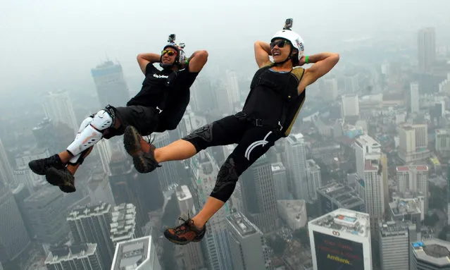 Base jumpers shrouded in haze shrouded in haze leap from the 300-metre high open deck at Malaysia's Kuala Lumpur Tower from the 300-metre high open deck at Malaysia's Kuala Lumpur Tower during the International Tower Jump on October 2, 2015 in Kuala Lumpur, Malaysia. More than 119 professional base jumpers from 20 countries include France, United States, Australia, Brazil, Germany, Canada and South Korea take a part. (Photo by Halim Berbar/SIPA Press/Rex Features/Shutterstock)