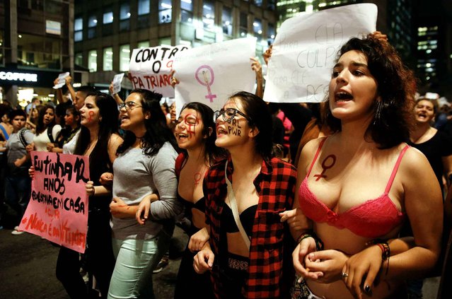 Women march during a protest against the gang rape of a 16-year-old girl in Sao Paulo, Brazil, Wednesday, June 1, 2016. In response to the assault, Brazil's interim President Michel Temer said that Brazil will set up a specialized group to fight violence against women. (Photo by Andre Penner/AP Photo)