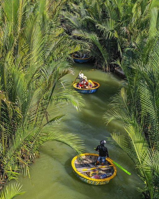 Tourists float through Bay Mau coconut forest on the coast of Hoi An, Vietnam in the last decade of May 2024. (Photo by Bui Phu Khanh/Solent News)