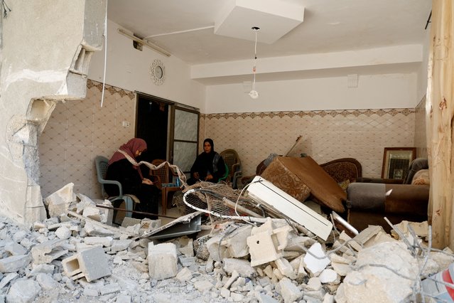 Palestinian women sit inside a damaged building, in the aftermath of an Israeli raid, in Tulkarm, in the Israeli-occupied West Bank, on July 23, 2024. (Photo by Raneen Sawafta/Reuters)