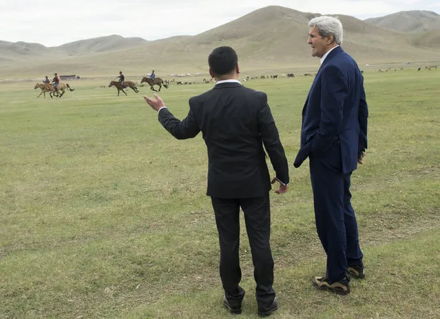 U.S. Secretary of State John Kerry (R) and Mongolian Foreign Minister Lundeg Purevsuren watch horse racing during a Naadam ceremony, a competition which traditionally includes horse racing, Mongolian wrestling and archery, in Ulan Bator, Mongolia, June 5, 2016. (Photo by Saul Loeb/Reuters)