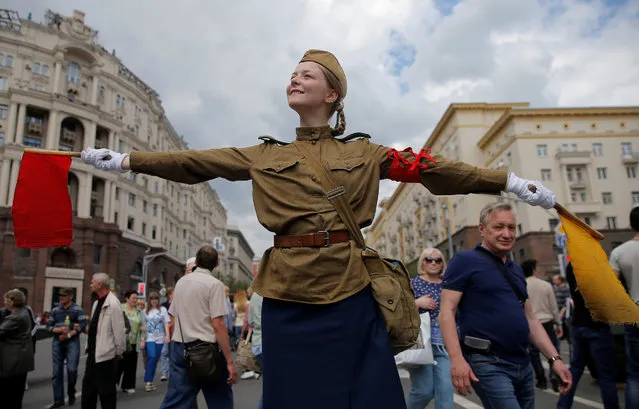 A performer dressed in a historical uniform takes part in a re-enactment festival which coincides with an anti-corruption protest organised by opposition leader Alexei Navalny, on Tverskaya Street in central Moscow, Russia, June 12, 2017. (Photo by Maxim Shemetov/Reuters)