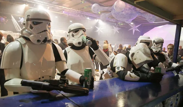 People dressed as Storm troopers stand at a bar as they pose for a photograph holding cans of beer at the “For The Love of The Force” Star Wars fan convention in Manchester, northern England, December 4, 2015. (Photo by Phil Noble/Reuters)