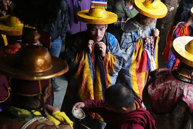 Elaborately dressed monks prepare to perform ceremonies in the main square during the Tenchi Festival on May 25, 2014 in Lo Manthang, Nepal. The Tenchi Festival takes place annually in Lo Manthang, the capital of Upper Mustang and the former Tibetan Kingdom of Lo. Each spring, monks perform ceremonies, rites, and dances during the Tenchi Festival to dispel evils and demons from the former kingdom. (Photo by Taylor Weidman/Getty Images)