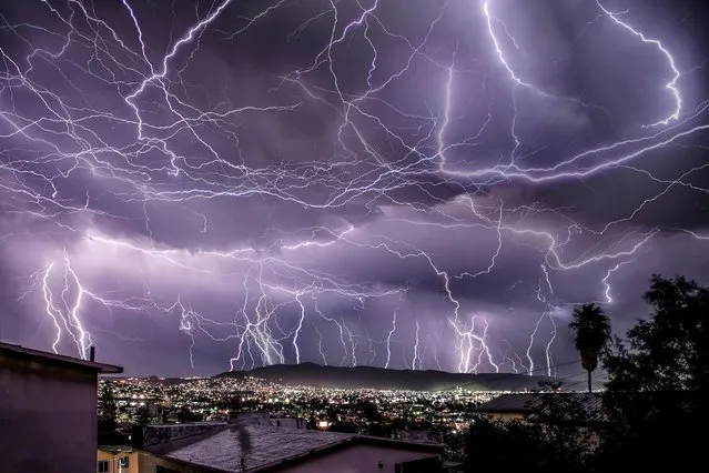 Horizontal lightning was captured in this picture taken over an hour in Ensenada, Mexico on October 28, 2021. (Photo by Edgar Lima/Animal News Agency)