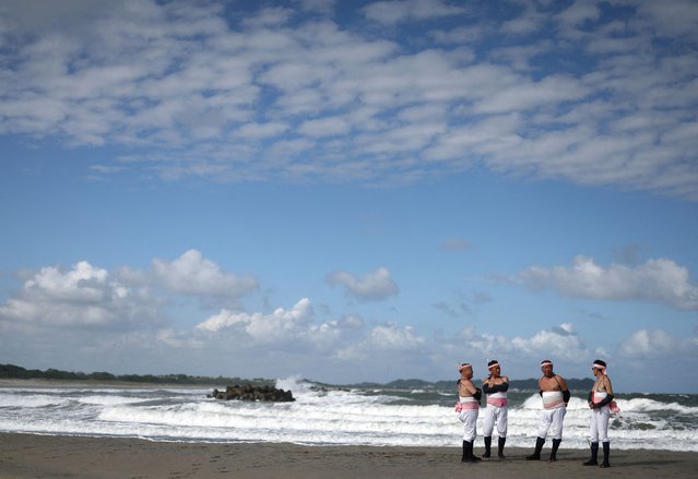 Participants stand on the beach while waiting for the start of the Ohara Hadaka Festival, which is held as part of the autumn celebration and prayers for a good harvest, in Isumi, Chiba Prefecture, Japan on September 23, 2024. (Photo by Kim Kyung-Hoon/Reuters)