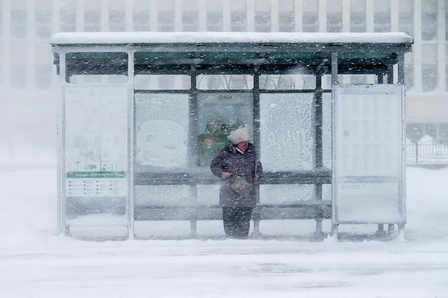 Women on a bus stop during a snowstorm in Yuzhno-Sakhalinsk, Russia on January 31, 2020. (Photo by Sergei Krasnoukhov/TASS)