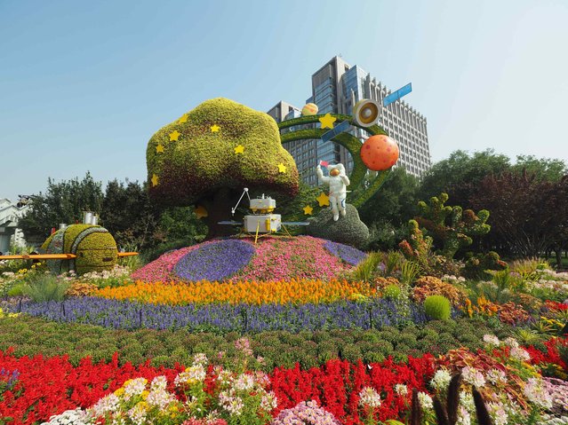 Themed flower beds are set up along the street to celebrate the upcoming Chinese National Day on September 24, 2024 in Beijing, China. (Photo by Du Jianpo/VCG via Getty Images)