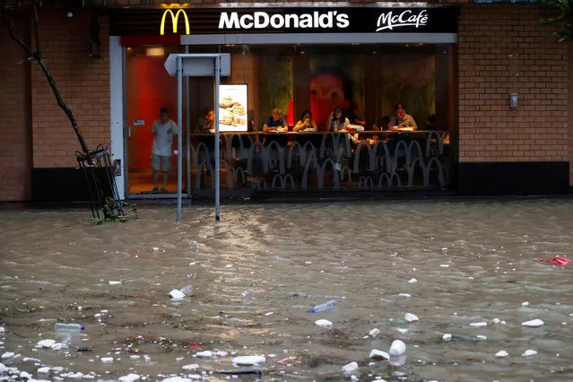 A flooded street is seen outside a McDonalds restaurant as Typhoon Hato hits Hong Kong, China on August 23, 2017. (Photo by Tyrone Siu/Reuters)