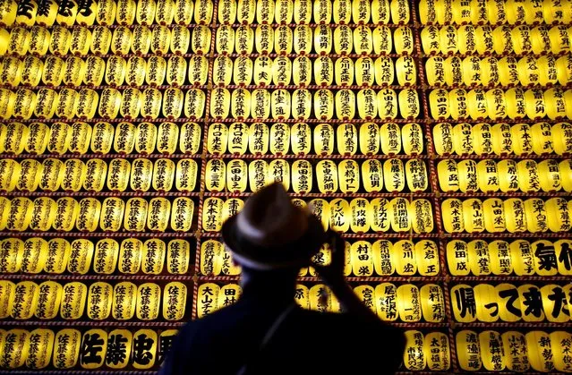 A man looks at thousands paper lanterns, which were displayed and lit up the precincts of the shrine, where more than 2.4 million war-dead are enshrined, during the Mitama Festival at Yasukuni Shrine in Tokyo, Japan July 13, 2016. (Photo by Issei Kato/Reuters)