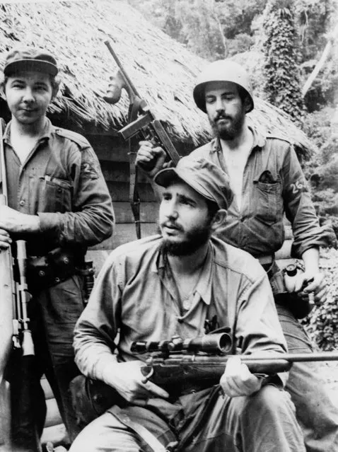 This March 14, 1957 file photo shows the young anti-Batista guerrilla leader Fidel Castro, center, with his younger brother Raul Castro, left, and Camilo Cienfuegos, right, operating in the mountains of eastern Cuba. Raul Castro, the current leader of the Communist-run island will turn 80 on Friday June 3. The milestone is sure to remind supporters and detractors alike that the era of the Castro's is nearing its end, biologically if not politically. Raul  is already a month older than Fidel was when a near-fatal illness forced him to step down in 2006. (Photo by Andrew St. George/AP Photo)