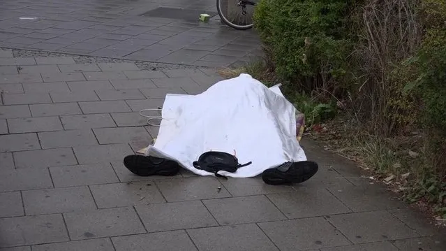 In this grab taken from video, a body covered with a sheet outside a mall, in Munich, Germany, Friday,  July 22, 2016. A manhunt was underway Friday for a shooter or shooters who opened fire at a shopping mall in Munich, killing and wounding several people, a Munich police spokeswoman said. The city transit system shut down and police asked people to avoid public places. (Photo by Nonstop News via AP Photo)