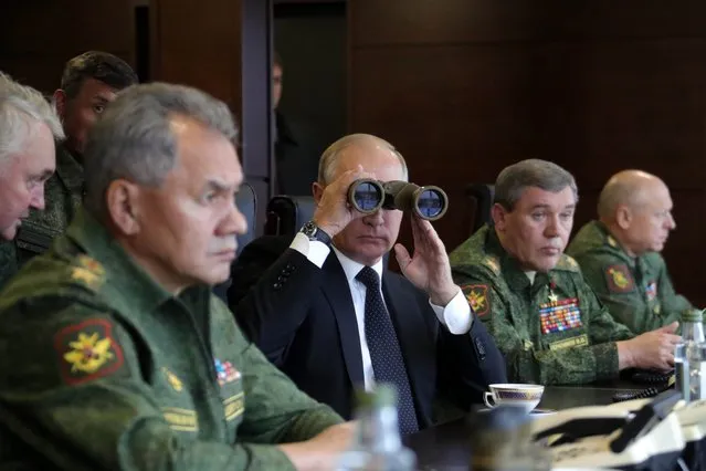 Russian President Vladimir Putin, center, Defence Minister Sergei Shoigu, left, and Chief of the General Staff of the Russian Armed Forces Valery Gerasimov, second right, watch a military exercise at a training ground at the Luzhsky Range, near St. Petersburg, Russia, Monday, September 18, 2017. The Zapad (West) 2017 maneuvers have caused concern among some NATO members neighboring Russia, who have criticized a lack of transparency about the exercises and questioned Moscow's real intentions. (Photo by Mikhail Klimentyev, Sputnik, Kremlin Pool Photo via AP Photo)