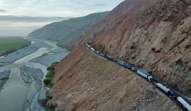 A drone image shows vehicles parked on a mountain road as small-scale miners halt traffic to demand the extension of a program that allows them to operate temporarily, but which authorities say has expanded illegal mining, in Ocona, Peru on November 27, 2024. (Photo by Oswald Charca/Reuters)