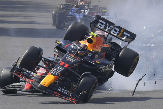 Red Bull Racing's Mexican driver Sergio Perez (R) crashes with Ferrari's Monegasque driver Charles Leclerc at the start of the Formula One Mexico Grand Prix at the Hermanos Rodriguez racetrack in Mexico City on October 29, 2023. (Photo by Claudio Cruz/AFP Photo)