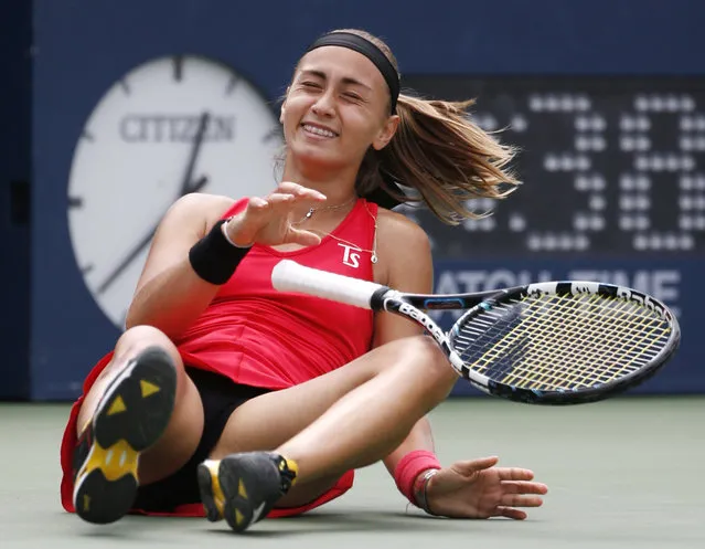 Aleksandra Krunic, of Serbia, drops to the court after defeating Petra Kvitova, of the Czech Republic, during the third round of the 2014 U.S. Open tennis tournament, Saturday, August 30, 2014, in New York. (Photo by Kathy Willens/AP Photo)