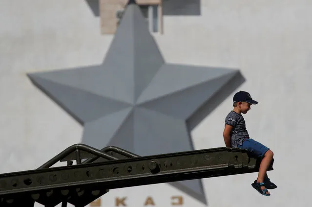 A boy sits on World War II Katyusha missile system in the centre of Volgograd, Russia, August 22, 2017. (Photo by Maxim Shemetov/Reuters)