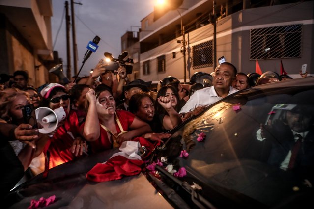 People celebrate the release of former President Alberto Fujimori at the Barbadillo prison in Lima, Peru on December 06, 2023. The Constitutional Court ordered the immediate release of former President Alberto Fujimori, who is serving a 25-year sentence for the Barrios Altos and La Cantuta cases in the Barbadillo prison. (Photo by Klebher Vasquez/Anadolu via Getty Images)