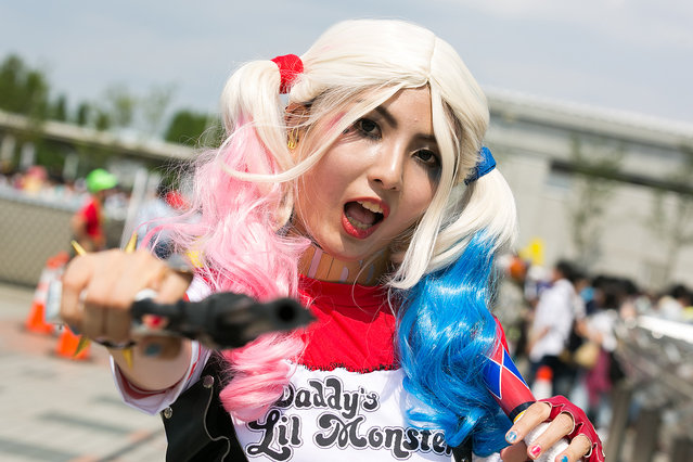 A cosplayer poses for a photograph during the Comic Market 90 (Comiket) event in Tokyo Big Sight on August 12, 2016, Tokyo, Japan. Many manga and anime fans wearing cosplay lined up in the sun for the first day of Comiket. Comiket was established in 1975 and focuses on manga, anime, gaming and cosplay. Organizers expect more than 500,000 visitors to attend this year's summer event which runs for three days until August 14. (Photo by Aflo/Splash News)