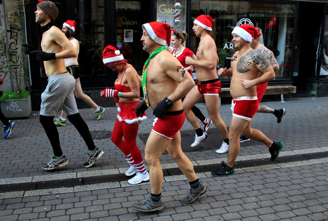 People take part in a half naked Santa run in downtown Budapest, Hungary, December 10, 2017. (Photo by Bernadett Szabo/Reuters)