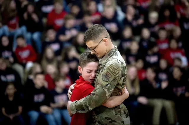 Easton Gunsell, 11, cries after rushing into his brother Braden Locker’s arms for an embrace after Locker, a 20-year-old airman, surprised him while Gunsell was competing in a free throw competition on Tuesday, November 22, 2022 at St. Robert Catholic School in Flushing. The Flushing native returned home for Thanksgiving with his family on a short leave from service for the U.S. Air Force while stationed in Saudi Arabia. “I was super happy to see him”, Gunsell said. ”I’m so proud of him”. (Photo by Jake May/The Flint Journal via AP Photo)