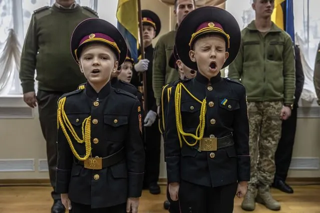 Young Ukrainian cadets sing during the ceremony of receiving shoulder straps at State Lyceum “Cadet Corps”, in Kyiv, Ukraine, 18 November 2022. Children as young as seven years of age are trained at the school to become military cadets. (Photo by Roman Pilipey/EPA/EFE)