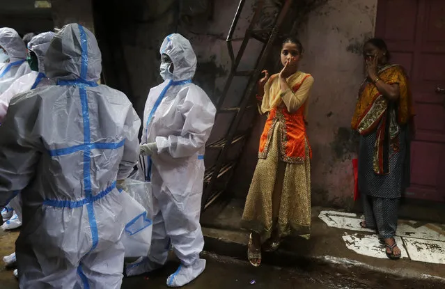 Health workers screen residents for COVID-19 symptoms at Dharavi, one of Asia's biggest slums, in Mumbai, India, Monday, August 3, 2020. India is the third hardest-hit country by the pandemic in the world after the United States and Brazil. (Photo by Rafiq Maqbool/AP Photo)