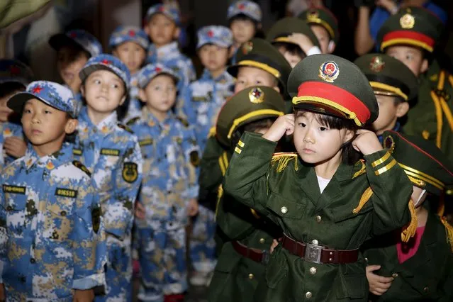 Children wearing uniforms stand in formation during a military parade game on China's National Day, at Beyou World, a centre where children can experience different kinds of professions, in Beijing, October 1, 2015. (Photo by Reuters/Stringer)