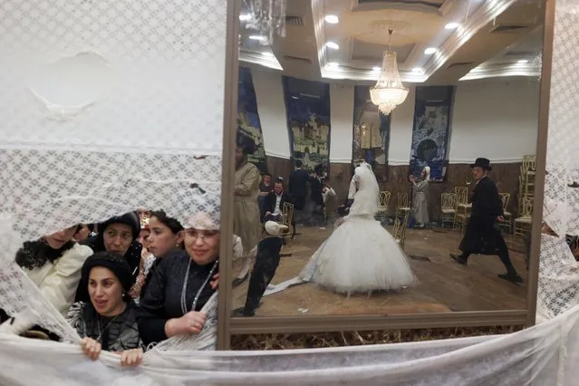 Ultra-Orthodox Jewish women look on from the women section as groom Moshe Lev and bride Ester Krois dance during their traditio​nal wedding ceremony in Jerusalem, Israel, 06 September 2022. (Photo by Abir Sultan/EPA/EFE)
