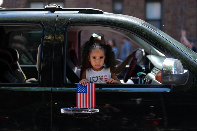 Francesca Perez, 4, holds the flag of the United States as she takes part in the 158th Memorial Day Parade, in the borough of Brooklyn in New York City, on May 26, 2025. (Photo by Adam Gray/Reuters)