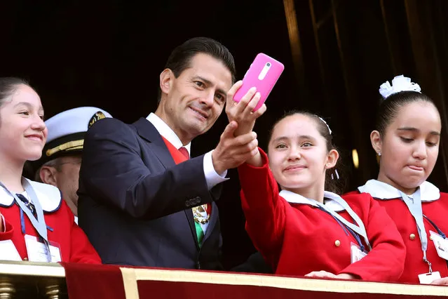 Mexico's President Enrique Pena Nieto takes a selfie with a student during a military parade celebrating Independence Day at Zocalo Square in downtown Mexico City, Mexico, September 16, 2016. (Photo by Edgard Garrido/Reuters)