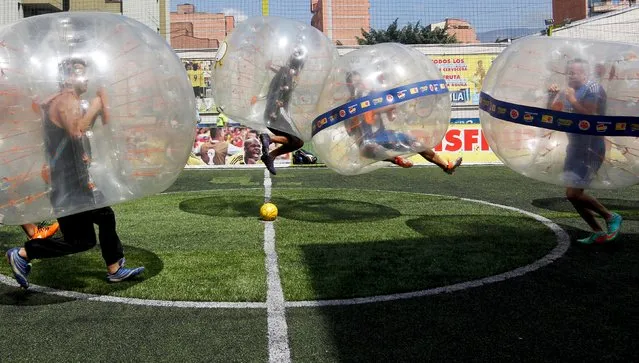 People take part in a game of 'bubble bump soccer' during an exhibition tournament in Medellin, Colombia, October 10, 2015. (Photo by Fredy Builes/Reuters)