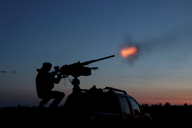 A serviceman from the mobile air defence unit of the 115th Separate Mechanized Brigade of the Ukrainian Armed Forces fires a Browning machine gun towards a Russian drone during an overnight shift, amid Russia's attack on Ukraine, in Kharkiv Region, Ukraine on June 2, 2025. (Photo by Sofiia Gatilova/Reuters)