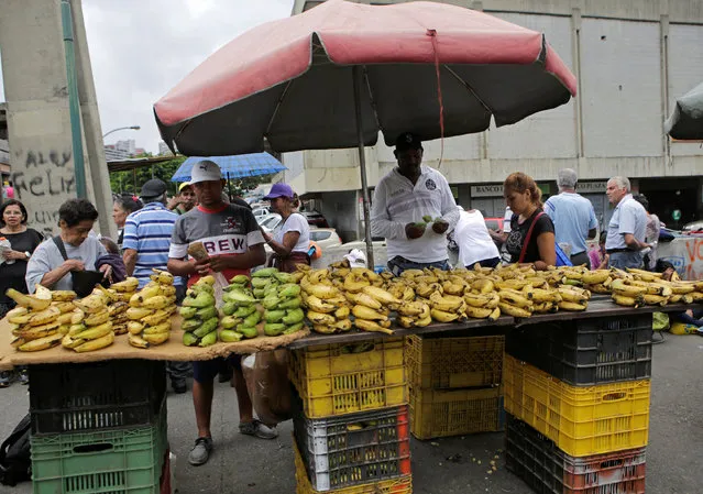 A vendor selling bananas waits for customers at his roadside stall in Caracas, Venezuela September 8, 2016. (Photo by Henry Romero/Reuters)