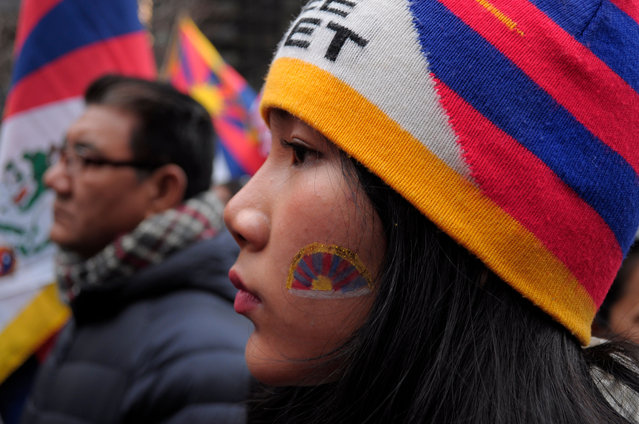 A pro-Tibet demonstrator with the Tibetan flag painted on her cheek, rallies at Dag Hammarskjöld Plaza near the United Nations building during the 65th Tibetan Uprising Day. Demonstrators rallied in Manhattan, New York City on March 10, 2024, demanding Tibet's independence from China. The Tibetan Uprising Day marks the day in 1959 when thousands of Tibetans in Tibet surrounded the palace of the current and 14th Dalai Lama. The Dalai Lama is the spiritual Buddhist leader of Tibetans worldwide. The Tibetans surrounded the palace in 1959 to protect the Dalai Lama due to fears of a Chinese government plot to abduct him. On March 17, 1959, the Dalai Lama was forced to flee from Tibet to India to escape the threat of the Chinese government. Since 1959, the Dalai Lama has been living in exile in Dharamshala in northern India. The Chinese communist chairman, Mao Zedong, annexed Tibet in 1950 after a military invasion. Annually on Tibetan Uprising Day, demonstrators globally hold rallies demanding human rights and independence for Tibet, which has been under Chinese rule for more than 70 years. (Photo by Jimin Kim/SOPA Images/Rex Features/Shutterstock)