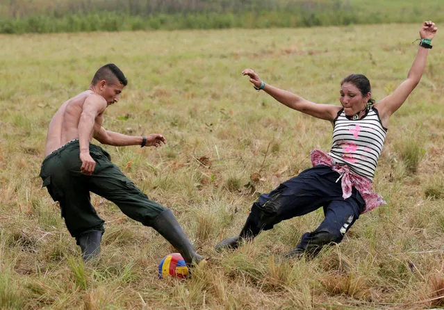 Fighters from Revolutionary Armed Forces of Colombia (FARC) play soccer at a camp where they prepare to ratify a peace deal with the government, near El Diamante in Yari Plains, Colombia, September 19, 2016. (Photo by John Vizcaino/Reuters)
