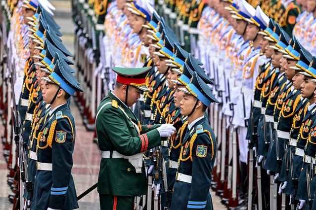 Members of a Vietnamese guard of honour prepare for a welcoming ceremony for Kyrgyzstan's Prime Minister Adylbek Kasymaliev at the Presidential Palace in Hanoi on March 6, 2025.  (Photo by Nhac Nguyen/AFP Photo)