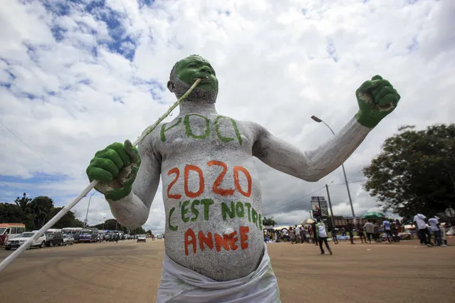 A supporter with body paint in French reading “PDCI, 2020, This is our year” attends a party rally to celebrate the presidential candidacy of Henri Konan Bedie for the opposition PDCI-RDA party and as a show of strength ahead of next months presidential election, in Yamoussoukro, Ivory Coast Saturday, September 12, 2020. Bedie, who led the country from 1993-1999, and Pascal Affi N'Guessan of the Ivorian Popular Front party, are the two opposition leaders who pose the strongest threat to incumbent President Alassane Ouattara. (Photo by Diomande Ble Blonde/AP Photo)