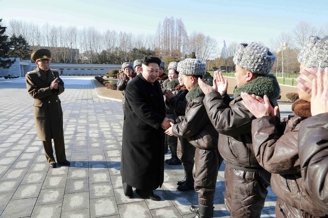 North Korean leader Kim Jong-un (C) shakes hands with fighter pilots during a photo session at the Workers' Party of Korea (WPK) Central Committee building in this undated photo released by North Korea's Korean Central News Agency (KCNA) in Pyongyang February 2, 2015. (Photo by Reuters/KCNA)