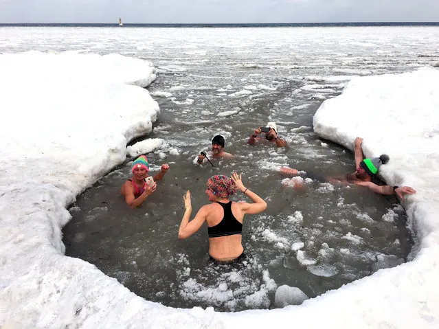 People take a bath in partly frozen Baltic sea in Sopot, Poland March 3, 2018. (Photo by Matej Leskovsek/Reuters)