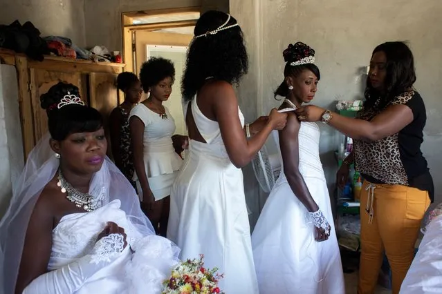 Brides Roselene Saint Juste and Mireille Mathurin, who got married in a joint ceremony to cousins Sony Vernet and Herve Vernet, get ready on their wedding day in Mariani, Haiti, April 15, 2017. (Photo by Valerie Baeriswyl/Reuters)