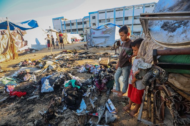 Palestinians, including children, examine the burnt makeshift tent, housing displaced Palestinians, and parts of the unmanned aerial vehicle (UAV) targeted by the Israeli army in Tel al-Hawa neighborhood of Gaza City, Gaza on August 31, 2025. It has been reported that there have been deaths and injuries as a result of the attack carried out by the Israeli army's unmanned aerial vehicle. (Photo by Hamza Z. H. Qraiqea/Anadolu via Getty Images)