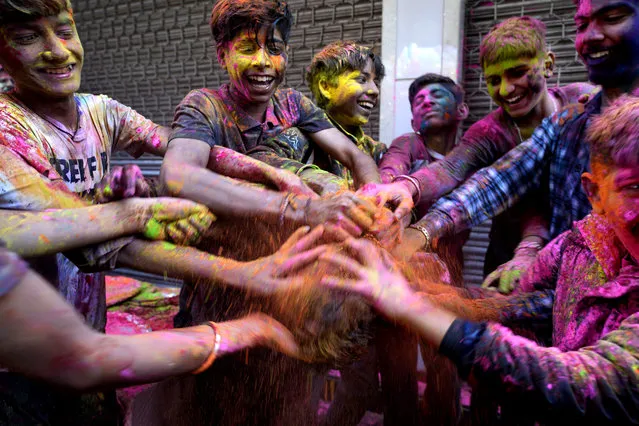 Children put colors on each other as they celebrate Holi, the Hindu festival of colors, in Jammu, India, Tuesday, March 7, 2023. (AP Photo/Channi Anand)