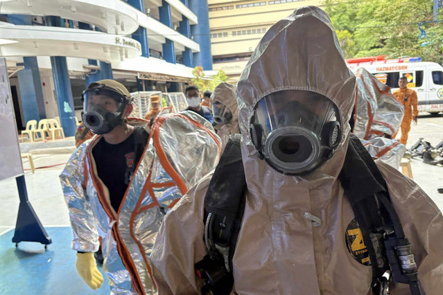 In this photo provided by the Bureau of Fire Protection, firefighters wear protective suits as they respond to a chemical spill incident at the San Pedro College following a strong earthquake in Davao City, southern Philippines on Friday October 10, 2025. (Photo byh Bureau of Fire Protection via AP Photo)