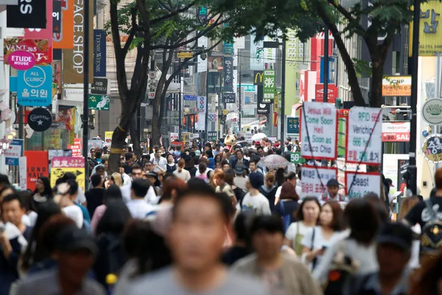 People walk in Myeongdong shopping district in Seoul, South Korea, May 31, 2016. (Photo by Kim Hong-Ji/Reuters)