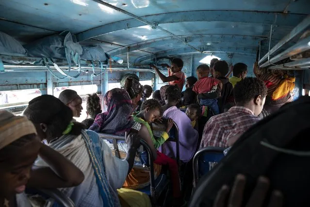 Tigray refugees who fled the conflict in the Ethiopia's Tigray ride a bus going to the Village 8 temporary shelter, near the Sudan-Ethiopia border, in Hamdayet, eastern Sudan, Tuesday, December 1, 2020. (Photo by Nariman El-Mofty/AP Photo)