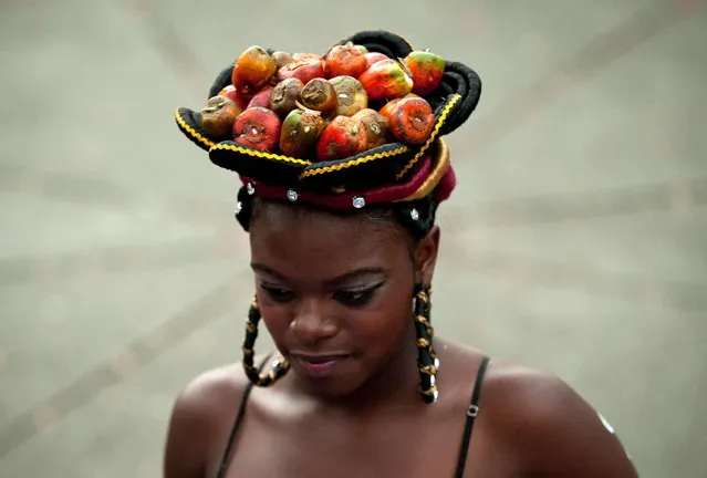 A woman presents an Afro-Colombian hairstyle during the 9th contest of Afro-hairdressers, in Cali, Valle del Cauca departament, Colombia, on May 12, 2013. The Afro hairstyles have their origins in the time of slavery, when women sat to comb their children hair after work. (Photo by Luis Robayo/AFP Photo)